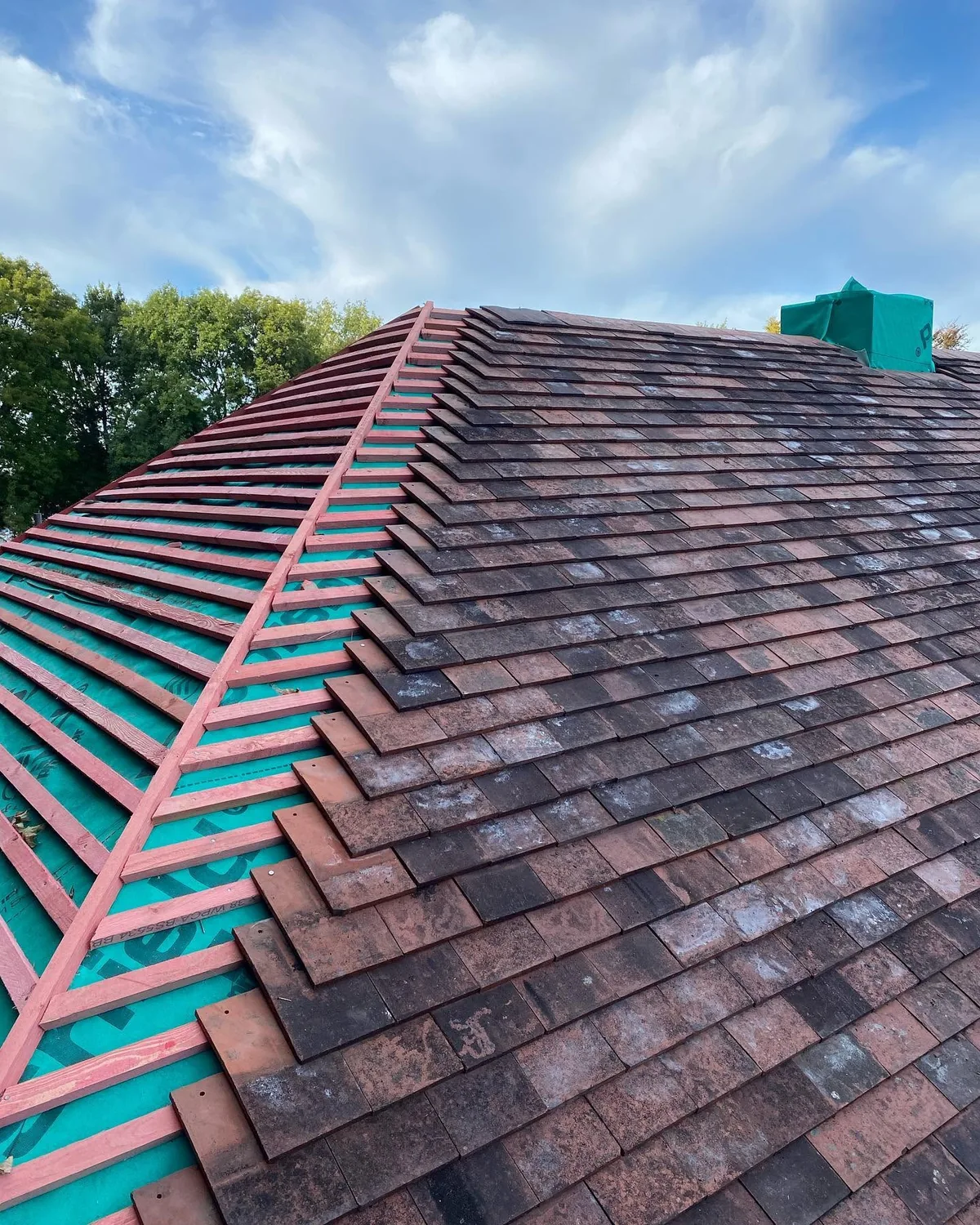 Roof repair with new battens and roof tiles being fitted